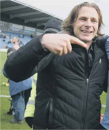  ??  ?? Wycombe Wanderers boss Gareth Ainsworth celebrates promotion with star striker Adebayo Akinfenwa.