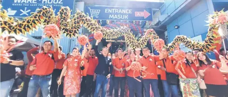  ?? ?? Tan (fourth left) and others jointly cutting the ribbon to mark the opening of Warehouz in Kolombong.