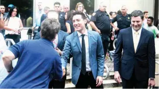  ?? Associated Press ?? David Daleiden, center, speaks with supporters Tuesday outside the Harris County Criminal Justice Center in Houston. A Texas judge on Tuesday dismissed the last remaining charge against, Daleiden and Sandra Merritt, two California anti-abortion...