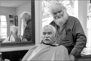  ?? Special to The Saline Courier ?? Herb Green prepares customer Terry Broadway, of Bryant, for a new cut at his shop.