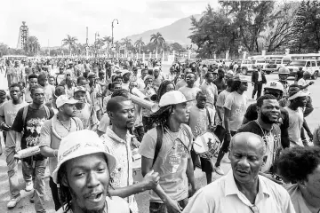  ??  ?? The crowd of supporters gather playing music in front of the national palace following the inaugurati­on of Moise in Port-au-Prince. — AFP photo