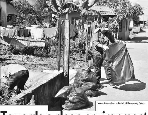  ??  ?? Volunteers clear rubbish at Kampung Bako.