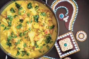  ??  ?? Fragrant with fennel seeds, cinnamon and curry leaves, potatoes and peas are cooked in an almond-coconut sauce for this kurma.