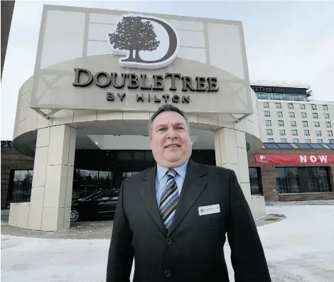  ?? JOHN LUCAS/EDMONTON JOURNAL ?? General manager Grant McCurdy stands in front of the newly opened DoubleTree by Hilton, which replaced the old Mayfield Inn in the city’s west end. There’s “nothing left” from the old hotel other than the dinner theatre, McCurdy says.