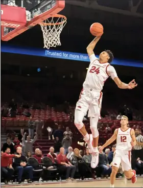  ?? Crant Osborne/Special to the News-Times ?? Jammin’: Arkansas' Ethan Henderson goes up for a dunk during the Razorbacks' exhibition game against Southwest Baptist last week in Fayettevil­le. On Friday, the Razorbacks open the regular season by taking on Texas.