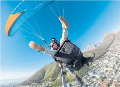  ??  ?? The writer’s son, Benjamin, takes to the skies while paraglidin­g in Cape Town.