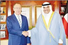  ??  ?? Kuwaiti Foreign Minister Sheikh Sabah Al-Khaled Al-Sabah (right) shaking hands with his Russian counterpar­t Sergey Lavrov following a meeting in Kuwait
City. (AFP)