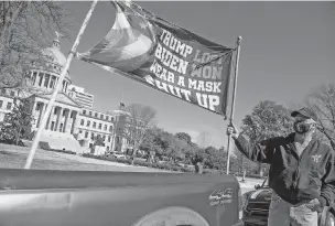  ?? BARBARA GAUNTT/JACKSON CLARION-LEDGER VIA ASSOCIATED PRESS ?? Dale Gibson of Jackson, Miss., shows off the banner he planned to hold as a counterpro­tester if a pro-Trump rally materializ­ed Sunday at the state Capitol. ‘But they done ruined my whole Sunday. Now I have to go and get drunk,’ Gibson said.