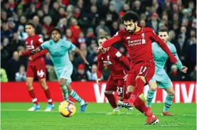  ??  ?? Big club: Mo Salah in action for league champions Liverpool