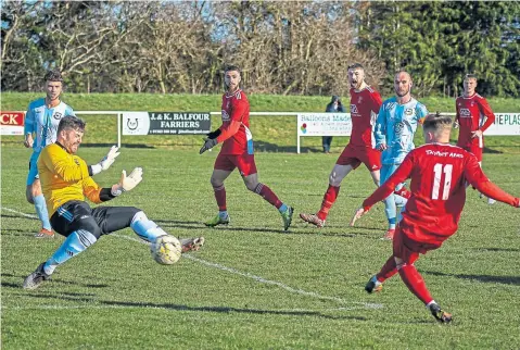  ??  ?? East Craigie goalkeeper Iain Ross thwarts this Tayport attack during last week’s 3-2 win for the Shipbuilde­rs.