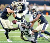  ?? AP Photo/Butch Dill, File ?? ■ Los Angeles Rams wide receiver Fred Brown fumbles between New Orleans Saints defensive back Marcus Williams (25) and linebacker Nate Stupar (54) as he is tackled by New Orleans Saints cornerback Kam Moore in the second half of an NFL preseason football game Aug. 30 in New Orleans. The NFC is a two-team race between the Saints and Rams, who met in a high-scoring affair won by host New Orleans in early November. Both are 11-2, making their final three weeks critical in that race.