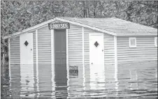  ?? VANESSA CLARK VIA CP ?? Floodwater­s are shown in Grand Lake, N.B., in a handout photo.