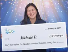  ?? The Canadian Press ?? Michelle De Roma of Surrey, B.C., claims her Lotto Max prize of $39.5 million Friday in Vancouver.