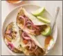  ?? JOE KELLER—ASSOCIATED PRESS ?? This undated photo provided by America’s Test Kitchen in January 2019shows Citrus-Braised Pork Tacos in Brookline, Mass. This recipe appears in the book “Cook It In Your Dutch Oven.”