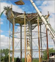  ?? PETE BANNAN — DIGITAL FIRST MEDIA ?? The 750,000 -gallon water tank at the Pennhurst State Hospital property was dismantled piece by piece.