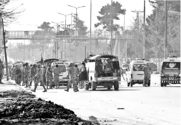  ??  ?? Army vehicles and ambulances gather outside the Bethel Memorial Methodist Church after an attack by gunmen, in Quetta. — Reuters photo