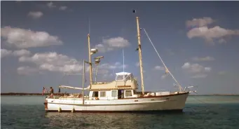  ??  ?? Above (top to bottom): Flopper stoppers engaged—namely two 18-foot booms hinged outboard, each carrying a 75-pound Vosper paravane and a fathom of chain to help stabilize the boat; Navigator 2 rests at anchor in more favorable conditions in the Bahamas.