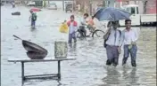  ?? PTI ?? People wade through a waterlogge­d road in Patiala on Saturday.