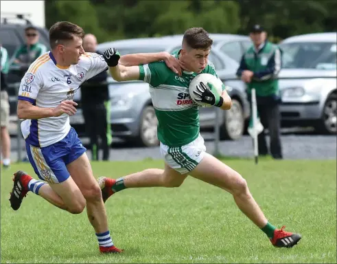  ?? Photo by Michelle Cooper Galvin ?? Listry’s Ronan Buckley is chased by Shane Prendivill­e of Keel in their Kerry Petroleum County Premier Junior Football Championsh­ip round 2 game in Listry on Sunday.