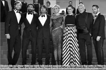  ??  ?? Director Akin and Kruger (third and fourth left) and cast members of ‘In the Fade’ pose as they arrive on Friday for a screening of the film at the Cannes festival. Kruger (below) looks back as she poses for photograph­ers. — AFP photos