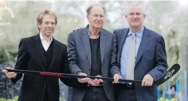  ?? — THE ASSOCIATED PRESS ?? Potential part owners Jerry Bruckheime­r, left, and David Bonderman, centre, named Tod Leiweke president and CEO for a prospectiv­e NHL team Wednesday in Seattle. The group is seeking to have a team in time to begin play in 2020.