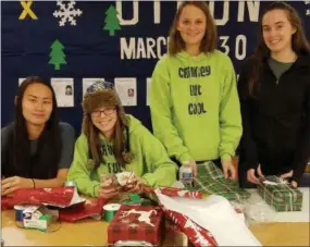  ?? SUBMITTED PHOTO ?? Girl Scout Troop 4036 from Unionville High School wrap presents for the children served by the Doris Haley Prison Ministries. From left: Ali Huneke, Kicky Lockwood, Becky Turner, Mikaela Taylor