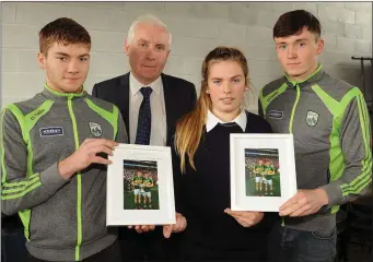  ?? Photos by Eamonn Keogh ?? All-Ireland winning Kerry minor footballer­s Brian Friel and Mark Ryan, past pupils of PS Sliabh Luanchra Rathmore, receiving a presentati­on from Sinead Warren (Students Council) and School Principal Denis Kerins.