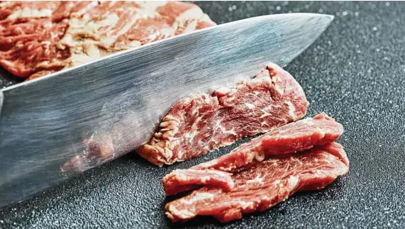  ?? Stacy Zarin Goldberg / Washington Post ?? Freezing meat for a brief time makes cutting easier. This tip also works for grating soft cheeses.