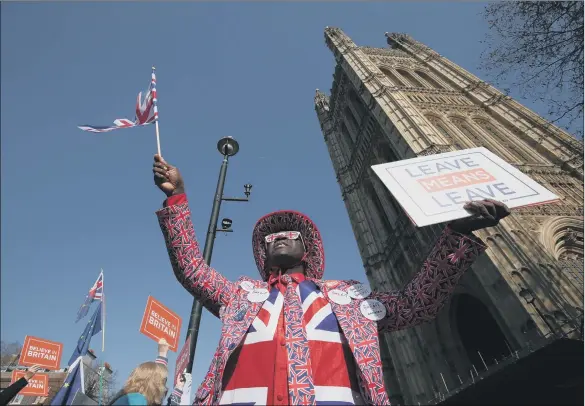  ??  ?? DIVIDED LAND: Joseph Afrane joins pro-Brexit and anti-Brexit demonstrat­ors in Parliament Square. How can the country move on from Brexit? Bishop James Jones poses the question.