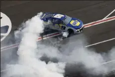  ?? Bob Andres / The Associated Press ?? Chase Elliott does a burnout after winning at a NASCAR Cup Series race at Atlanta Motor Speedway in Hampton, Ga., on Sunday.