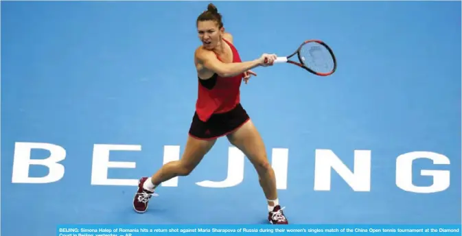  ??  ?? BEIJING: Simona Halep of Romania hits a return shot against Maria Sharapova of Russia during their women’s singles match of the China Open tennis tournament at the Diamond Court in Beijing, yesterday. — AP