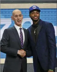  ?? KEVIN HAGEN — THE ASSOCIATED PRESS ?? Villanova’s Mikal Bridges, right, poses with NBA Commission­er Adam Silver after he was picked 10th overall by the 76ers in New York, Thursday.