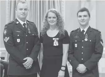  ?? SGT JOHANIE MAHEU ?? Gov.-Gen. Julie Payette presents the Medal of Bravery to Master Cpl. Alexander Zawyrucha, left, and Cpl Matthew Thomas Lepain of the Windsor Regiment, for their efforts in saving a woman from a car.