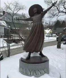  ?? Nick Perry/Associated Press ?? A bronze statue of Pollyanna sits outside the public library in Littleton, N.H., to honor the 1913 book by local author Eleanor H. Porter. The book’s main character came to define relentless optimism. Pollyanna’s motto was “Be Glad!”