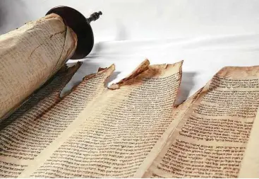  ?? Stephen Elliot / Smithsonia­n Institutio­n ?? A Torah burned by British troops in the Revolution­ary War is part of the “Religion in Early America” exhibit at the National Museum of American History in Washington, D.C.
