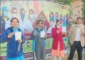  ?? HT PHOTO ?? Health workers show off their vaccinatio­n cards after taking the shot in Prayagraj on Friday.