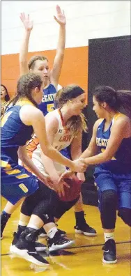  ?? Westside Eagle Observer/MIKE ECKELS ?? Lady Bulldogs Sammie Skaggs (left), Paige Vann and Kaylee Morales surround a Lady Engineer player trying to get to the basket during the second quarter of the Watts-Decatur basketball game in the high school gym at Watts, Okla., Dec. 18.