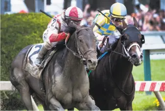  ?? Skip Dickstein / Albany Times Union ?? Cloud Computing (left) with Javier Castellano up, catches Classic Empire and Julien Leparoux at the wire to win the 142nd running of the Preakness Stakes at Pimlico Race Course.