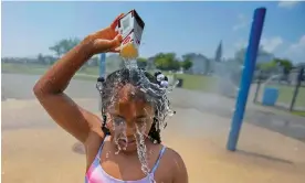  ?? Photograph: Peter Pereira/AP ?? Ja-Veah Cheney, nine, pours water over her head in the sweltering heat at Riverside Park in New Bedford, Massachuse­tts, on Wednesday.