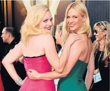  ??  ?? Colourful combinatio­n: Mad Men stars Elisabeth Moss and January Jones at the Primetime Emmy Awards in Los Angeles