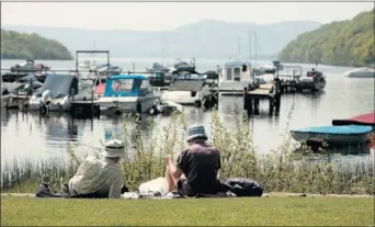  ?? Picture: Steve Cox ?? NATIONAL TREASURE: Ramblers relax by the boat yard on the shores of Loch Lomond at Balmaha.