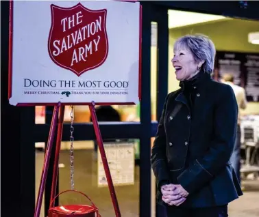  ?? (Photo by Logan Kirkland, SDN) ?? Mayor Lynn Spruill greets Starkville residents as they enter Kroger to help bring in donations for the Salvation Army's Red Kettle Campaign on Thursday.