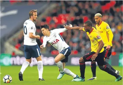  ?? Picture: Getty. ?? Christian Kabasele of Watford and Heung-Min Son of Tottenham Hotspur battle for possession.