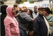  ?? JEENAH MOON — THE ASSOCIATED PRESS ?? Two people embrace at the scene of a shooting in the Brooklyn borough of New York on Saturday.