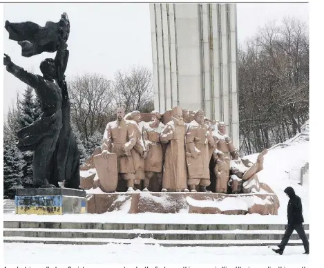  ?? EFREM LUKATSKY/THE ASSOCIATED PRESS ?? A pedestrian walks by a Soviet-era monument under the first snow this season in Kiev, Ukraine, earlier this month.