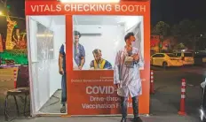  ?? Bloomberg ?? A vitals checking booth at a drive-through vaccinatio­n centre at Qaddafi Stadium in Lahore, Pakistan, on Thursday.