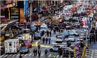  ?? ANDRES KUDACKI / ASSOCIATED PRESS ?? Law enforcemen­t officials work following an explosion near New York’s Times Square on Monday. Police said a man with a pipe bomb strapped to his body set off the crude device in a passageway under 42nd Street between Seventh and Eighth avenues.