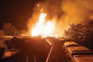  ?? AP Photo/Chris Mumma, File ?? Flames rise from a derailed freight train July 11, 2012, in Columbus, Ohio. A little-known truth about North American railroads is that no rules govern when rail becomes too worn down. Since 2000, U.S. officials blamed rail wear as the direct cause of...