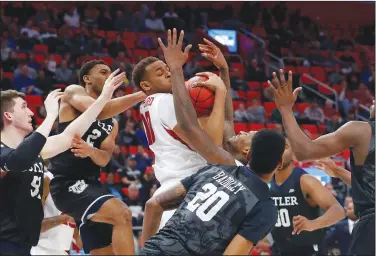  ?? Associated Press ?? Tough board: Arkansas forward Daniel Gafford (10) pulls down a rebound between Butler defenders during the first half of their first-round game in the NCAA Tournament in Detroit last month.