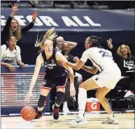  ?? Gary Landers / Associated Press ?? UConn guard Paige Bueckers (5) drives against Xavier forward A’Riana Gray (21) during the first half on Saturday.
